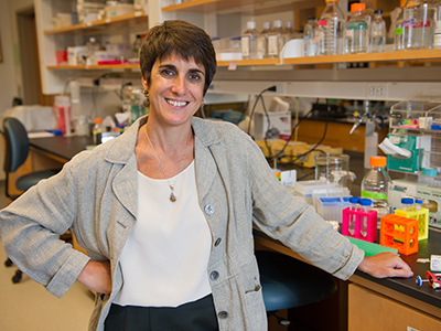 Professor Hewett poses in her laboratory