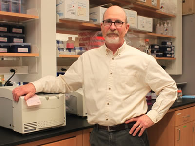 James Hewett poses in his laboratory