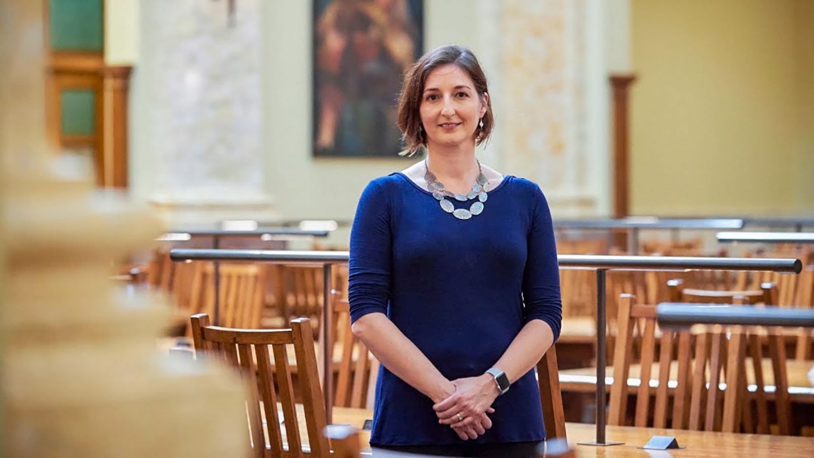 Lisa Manning stands among desks