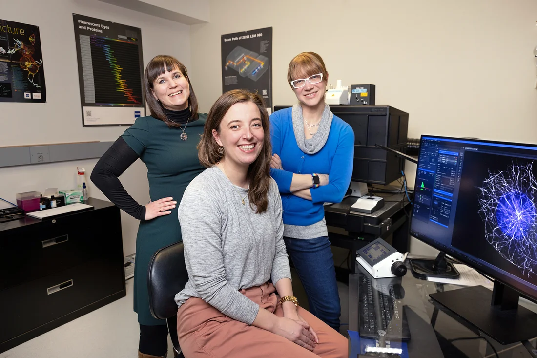 Professors Hehnly, Skanata, and Ross stand in a microscopy lab.