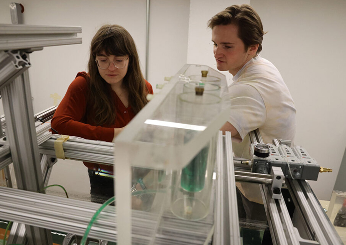 Kasey Laurant and Cody Van Nostrant with water machine in lab